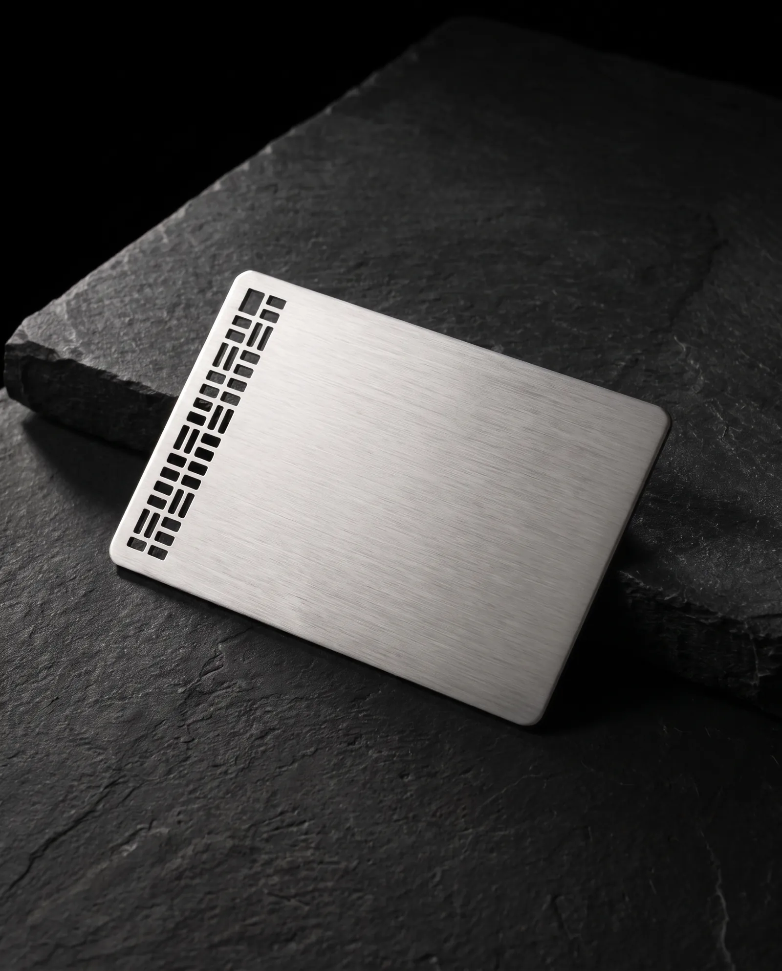 Brushed stainless card with a laser-cut pattern held in place by small bridges